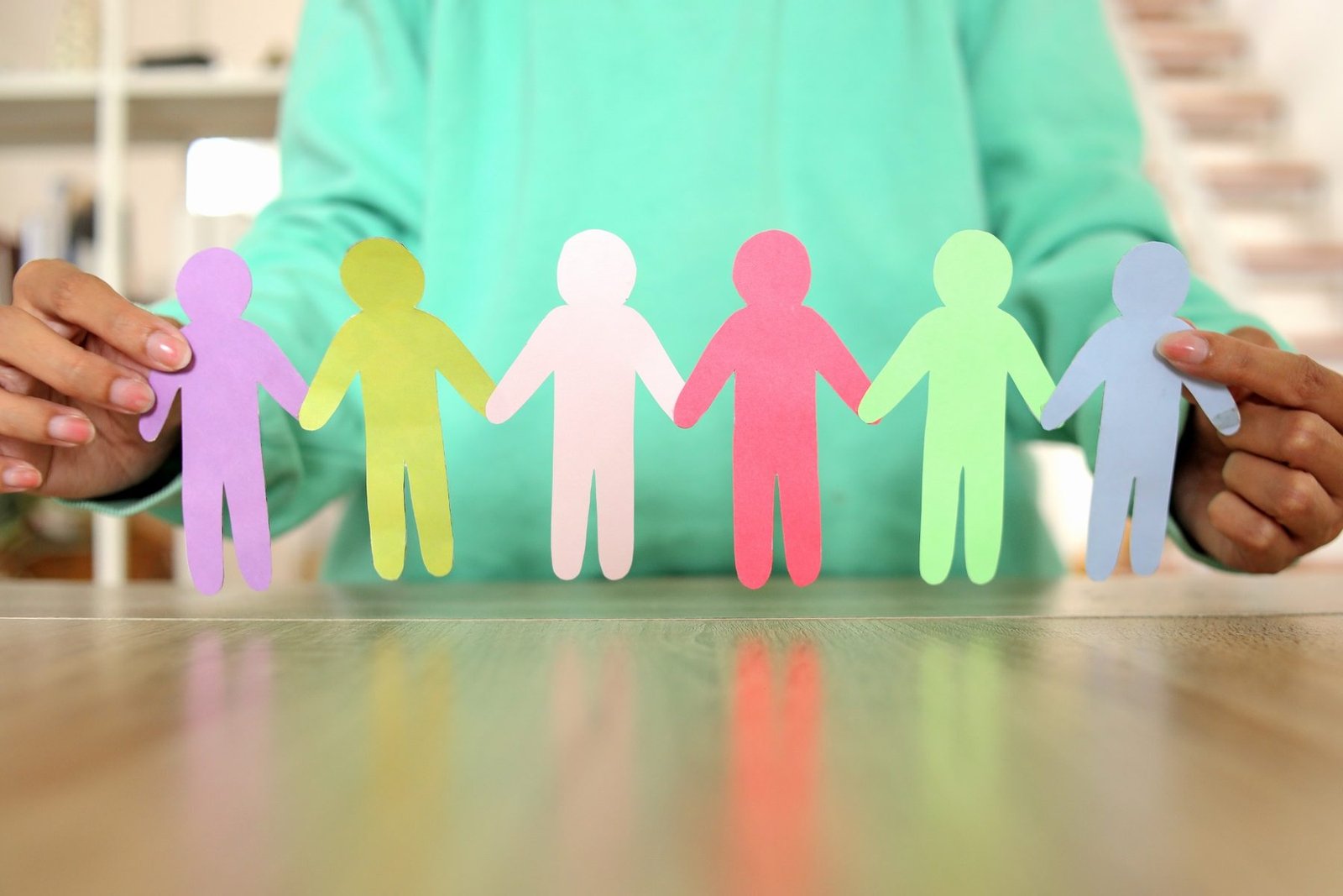 Colorful paper figures representing family connection and support